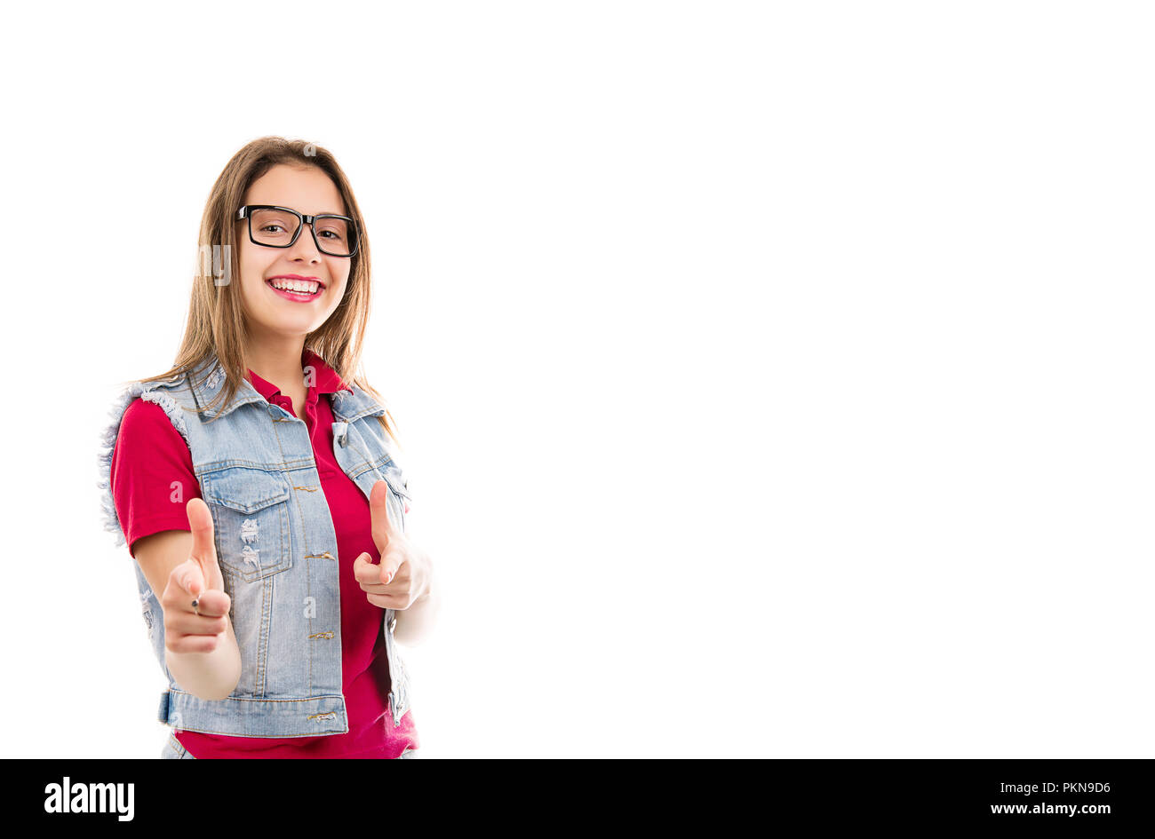 Pretty young teenage woman pointing at camera looking happy and cool isolated on white background Stock Photo