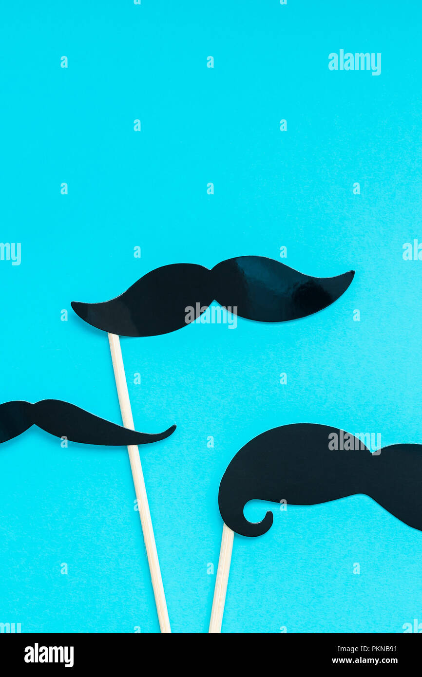 Creative flatlay overhead top view retro stylish black paper photo booth props moustaches turquoise background copy space. Men health awareness month  Stock Photo