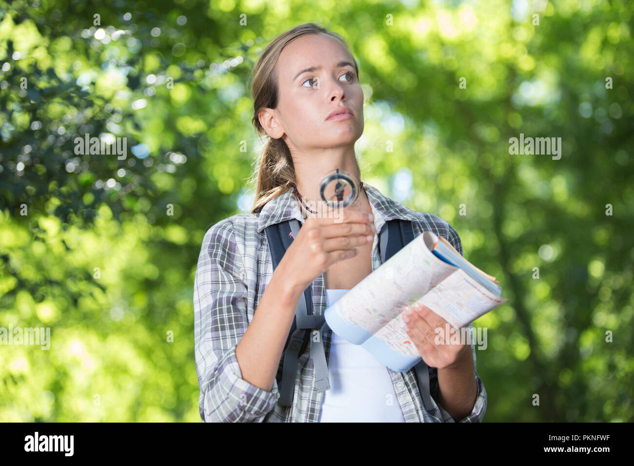 Female hiker looking compass hi-res stock photography and images - Alamy