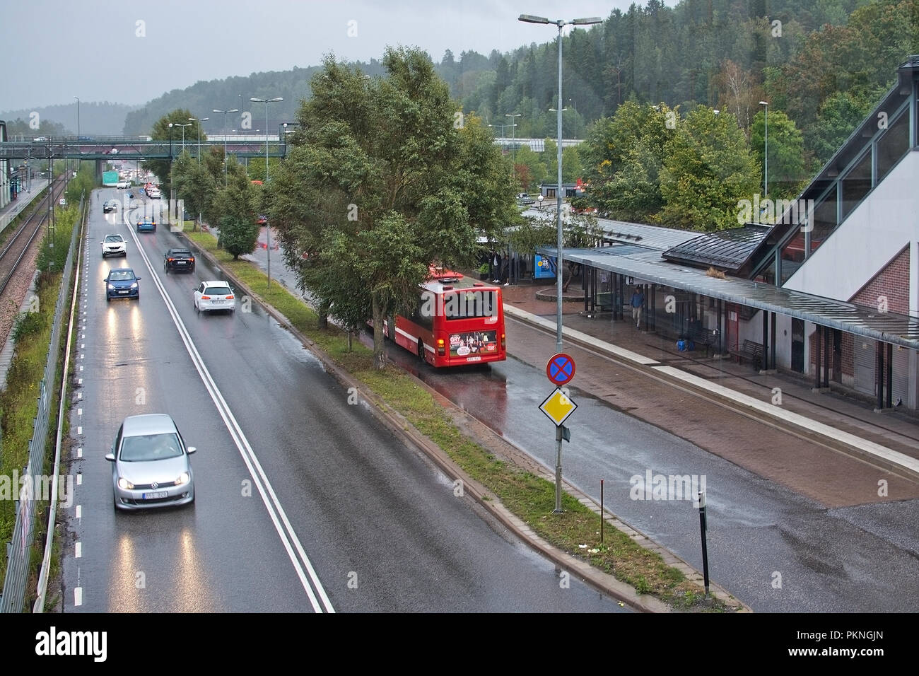 TUMBA, SWEDEN SEPTEMBER 11, 2018 Car traffic and bus station in rain