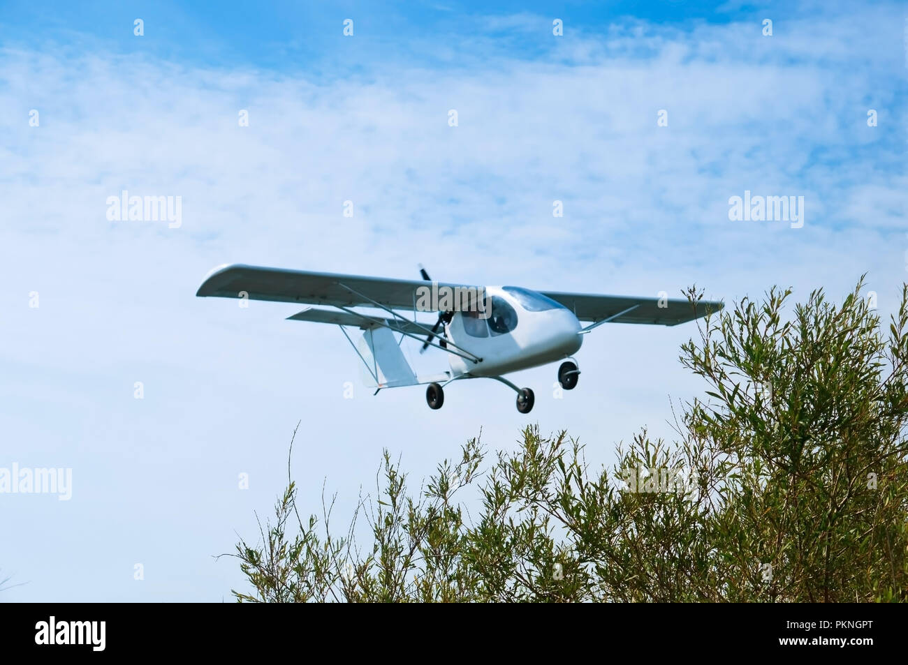 small white plane flying, glider in the sky, small aircraft in flight Stock Photo