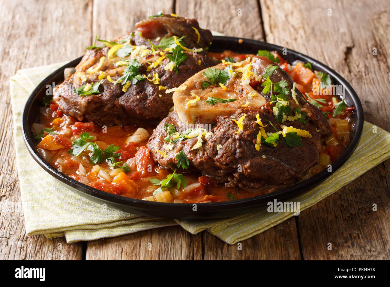 Italian menu braised veal steak Ossobuco alla Milanese with gremolata