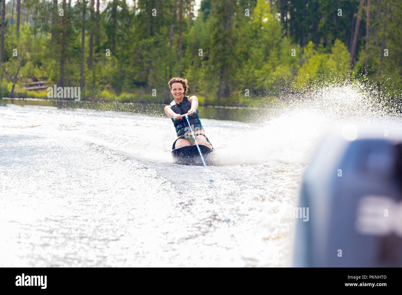 Young athletic woman riding kneeboard on a lake Stock Photo Alamy