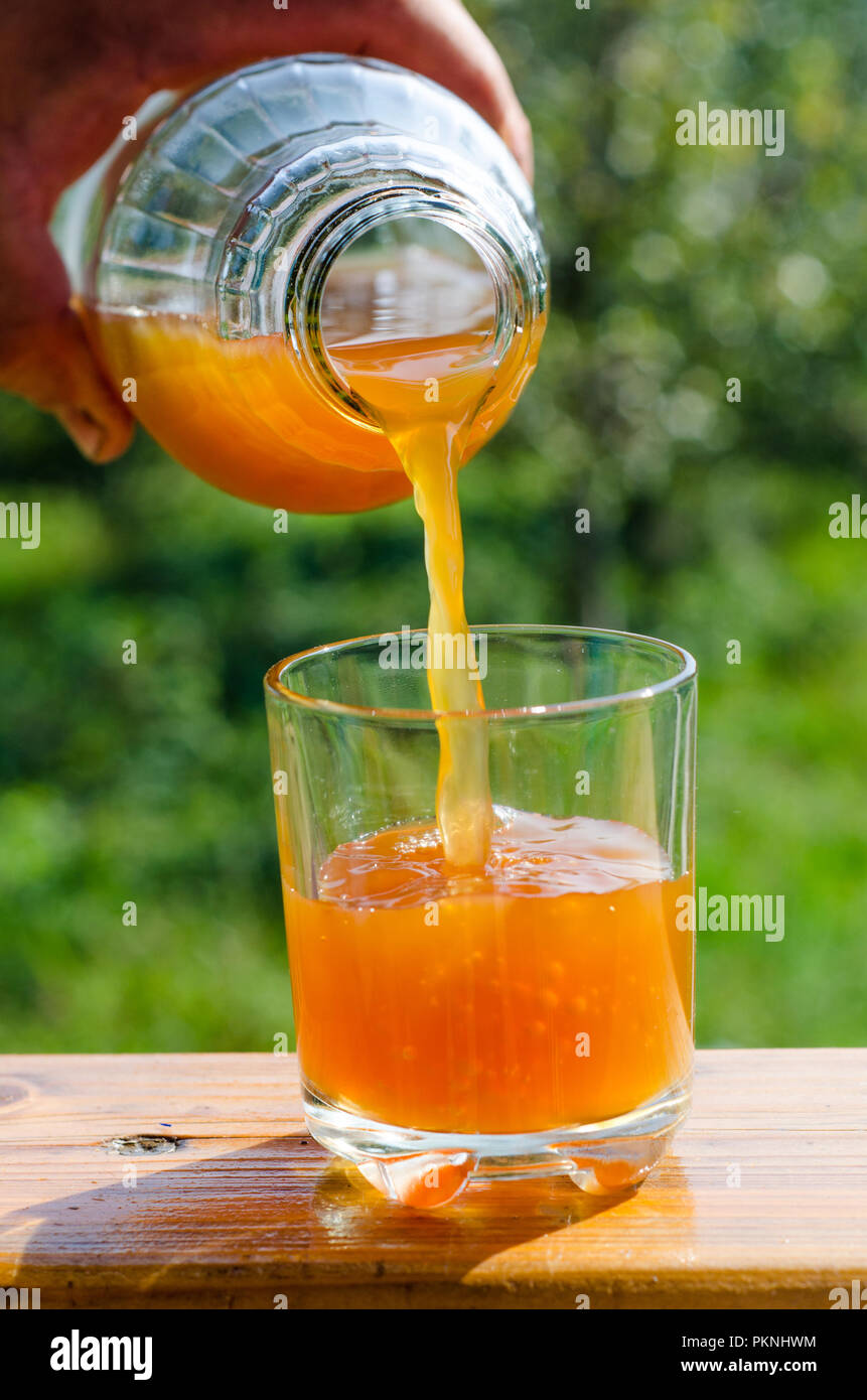 pouring fresh raw unfiltered apple juice into a glass Stock Photo Alamy