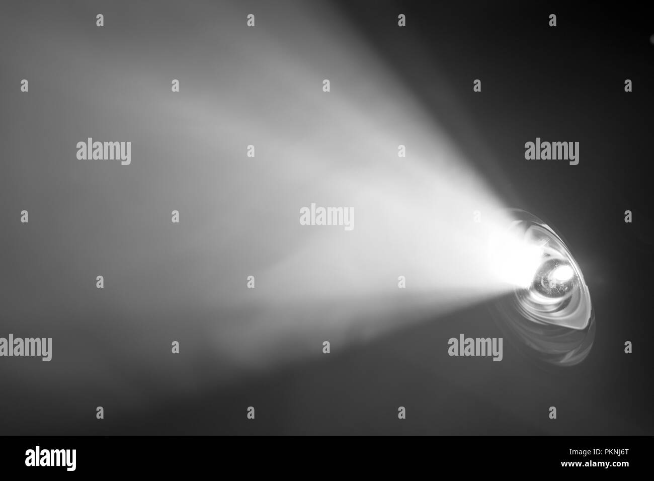 beautiful black and white color wide lens projector with light beam for movie and cinema at night . smoke texture spotlight . screening for multimedia Stock Photo