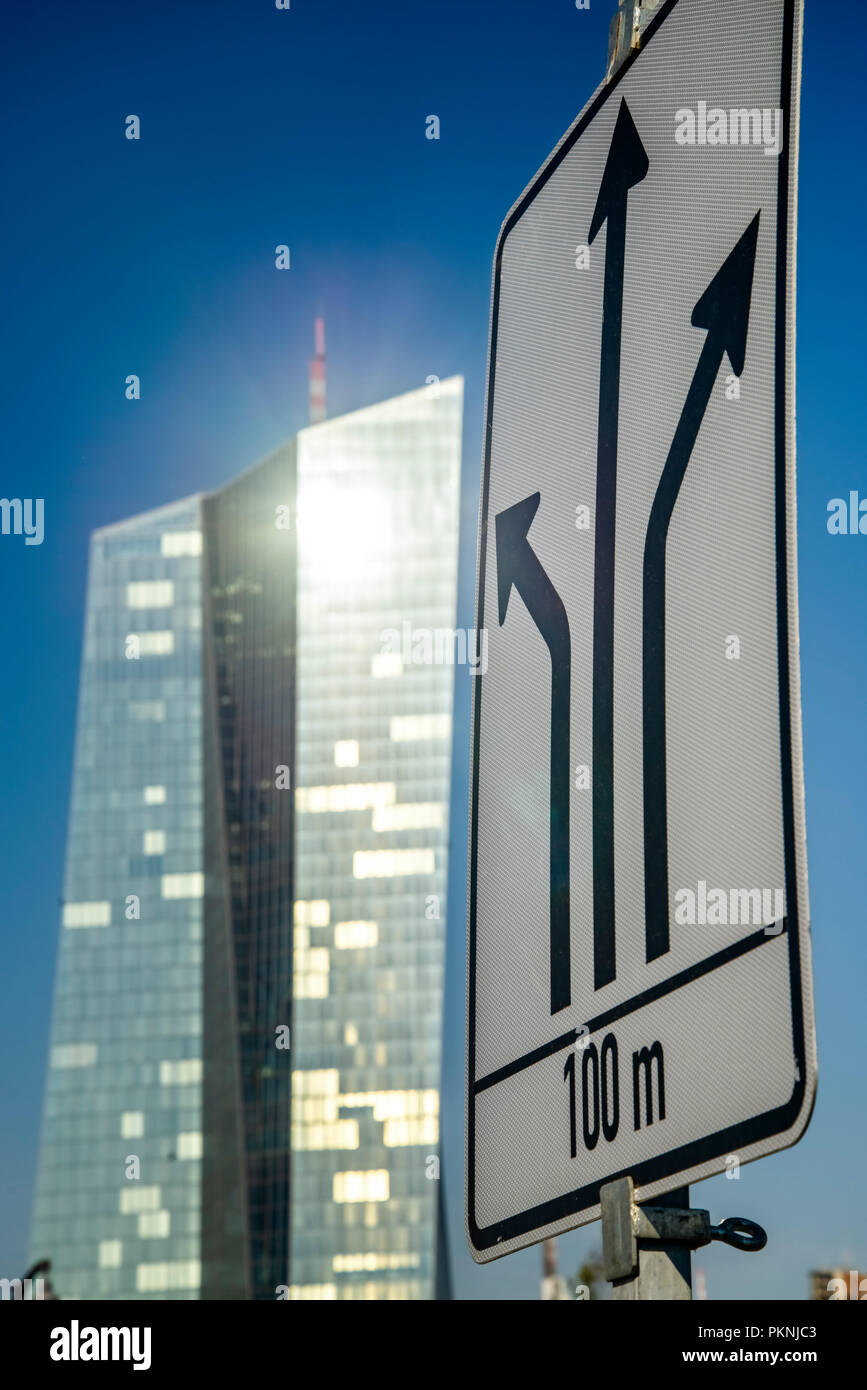 Road sign of a construction site with directional signs and the building of the European Central Bank (ECB) in the background. Stock Photo