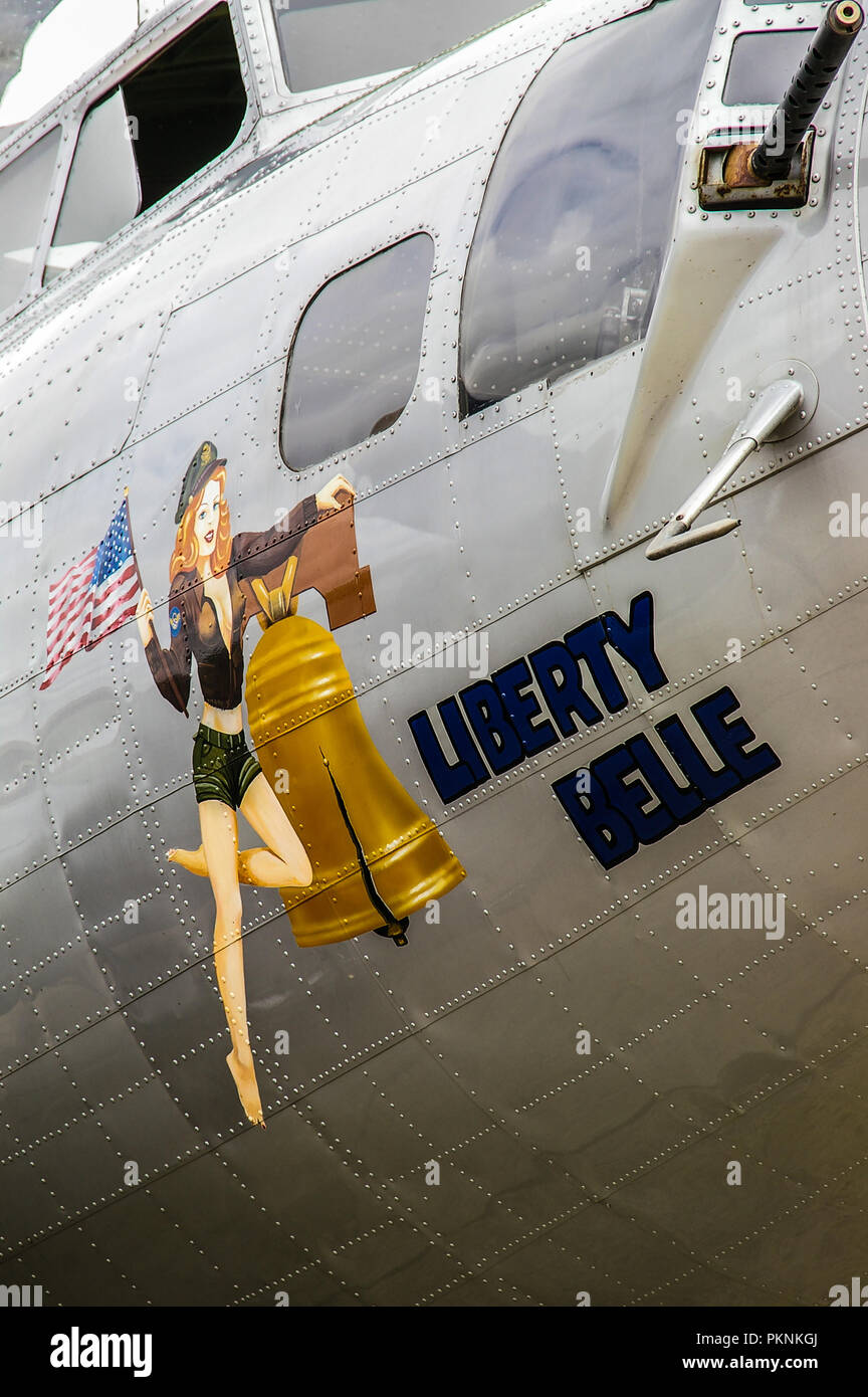 Boeing B-17 Flying Fortress named Liberty Belle with female pin up nose art. USAAF Second World War bomber plane. Gun Stock Photo