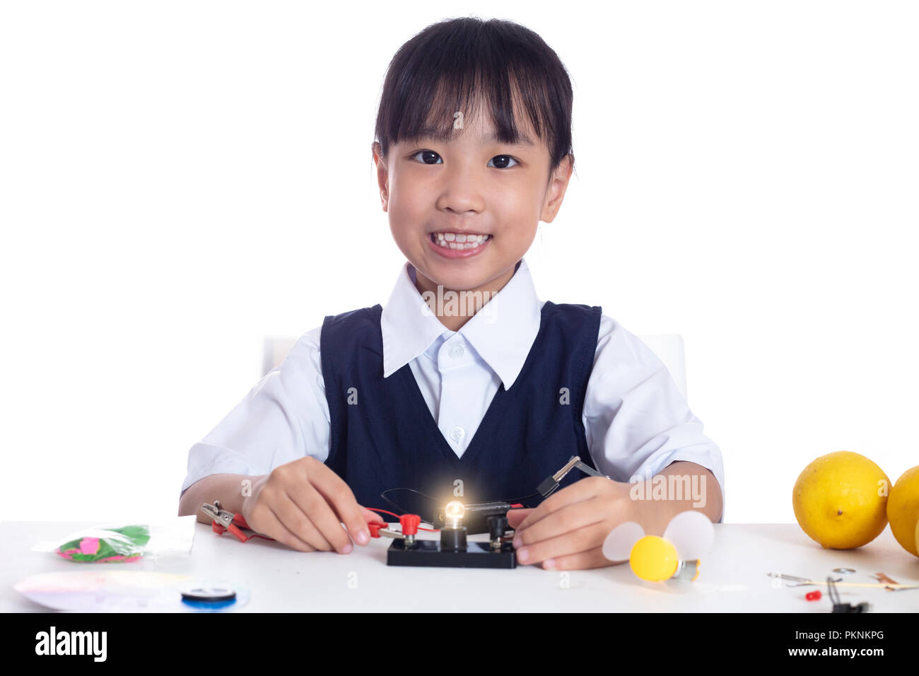 Asian chinese little girl doing experiments in isolated white ...