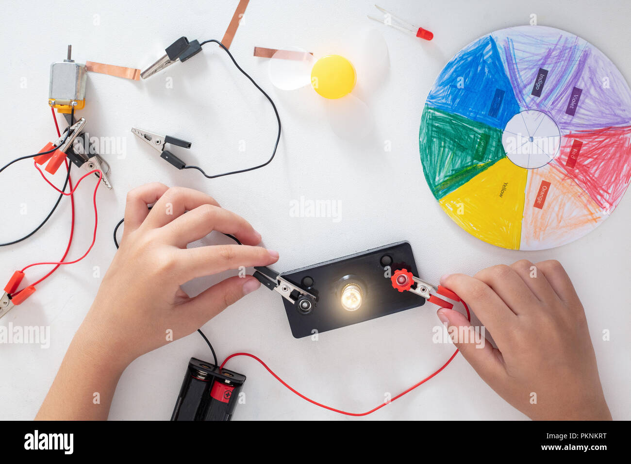 Children's hands doing experiments in isolated white background Stock Photo