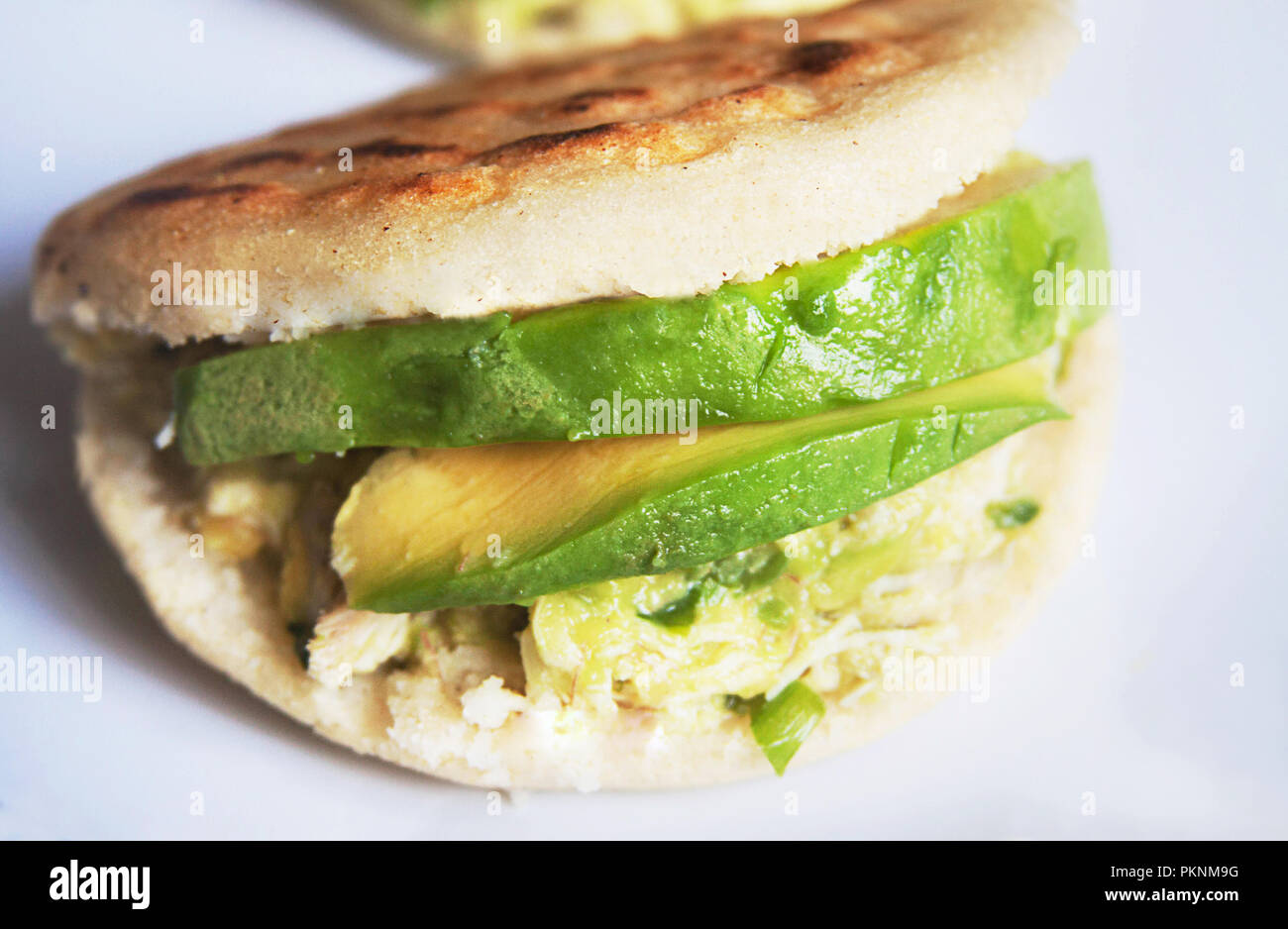 https://c8.alamy.com/comp/PKNM9G/venezuelan-arepas-here-homemade-venezuelan-arepas-close-up-reina-pepiada-avocado-and-chicken-arepa-PKNM9G.jpg