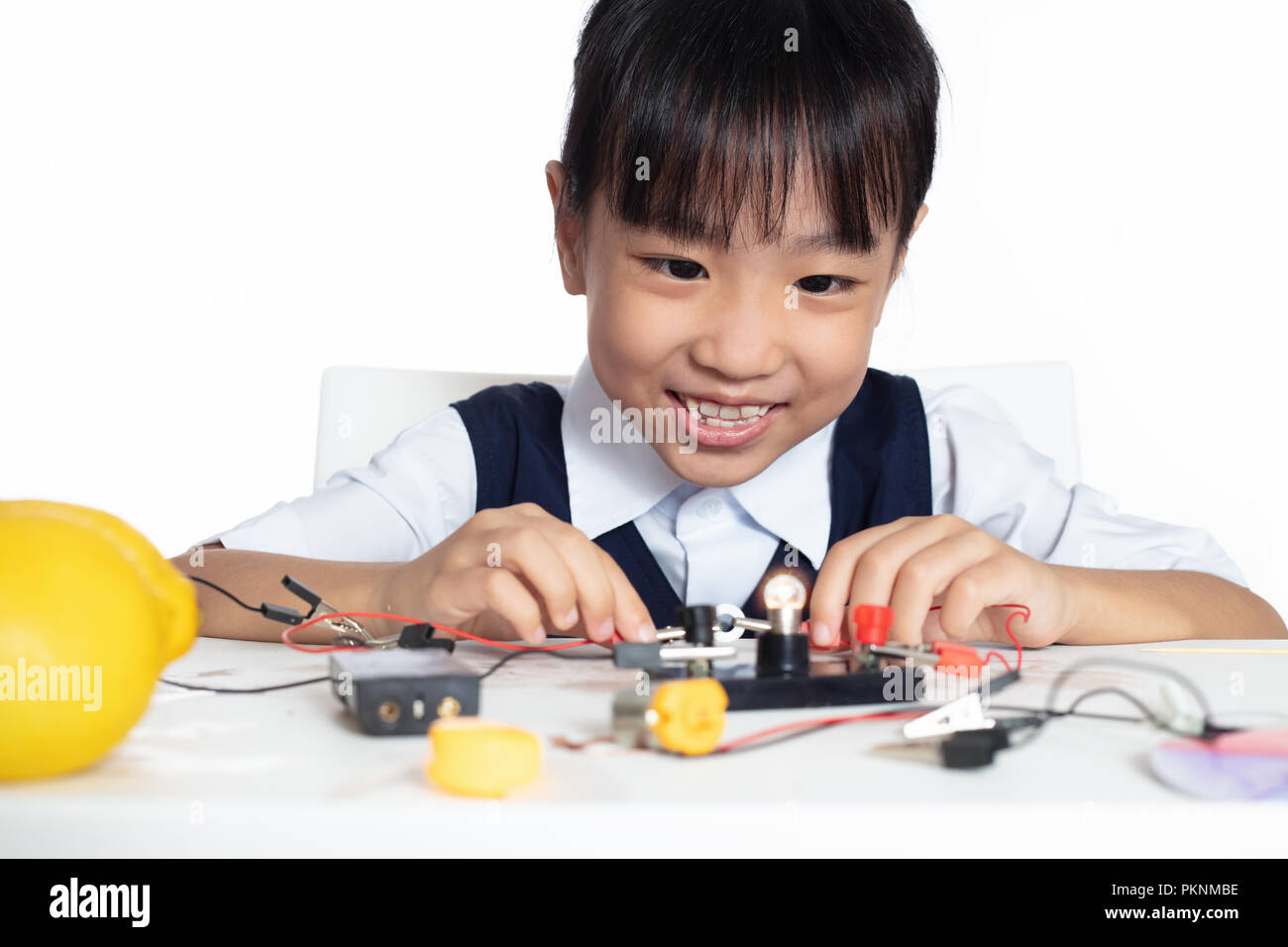 Asian chinese little girl doing experiments in isolated white ...