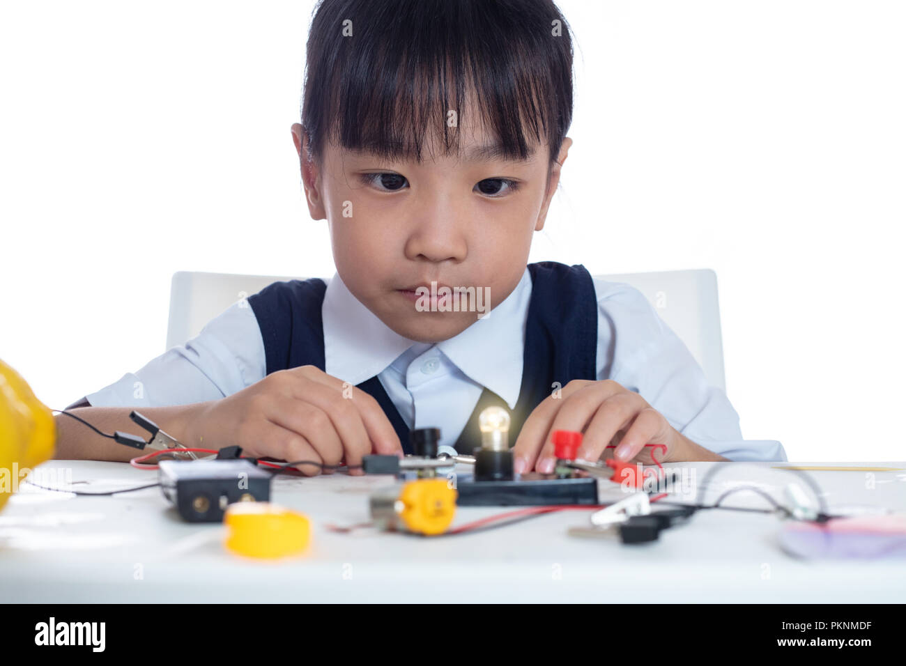 Asian chinese little girl doing experiments in isolated white ...
