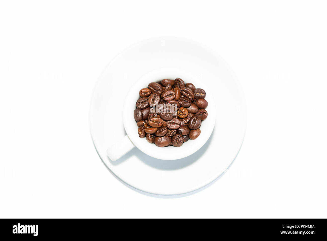 coffee cup full of roasted coffee beans and white background Stock Photo