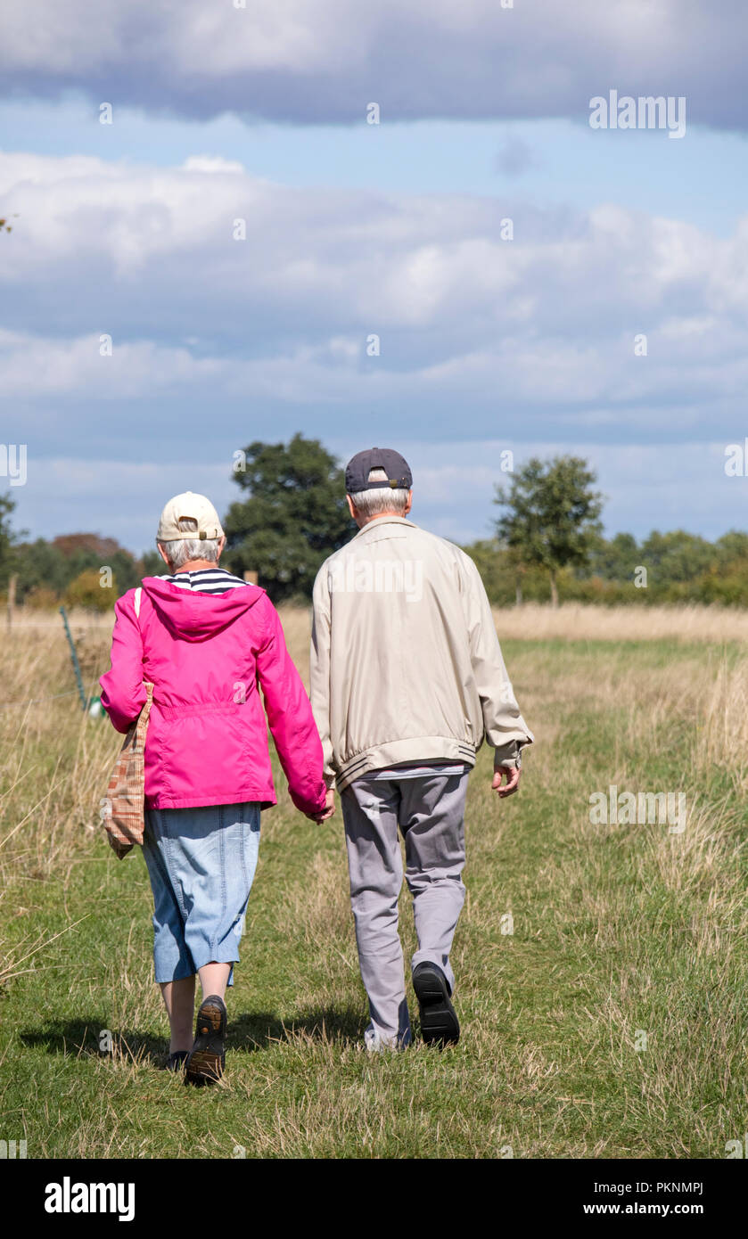 Elderly couple on a country walk, England, UK Stock Photo