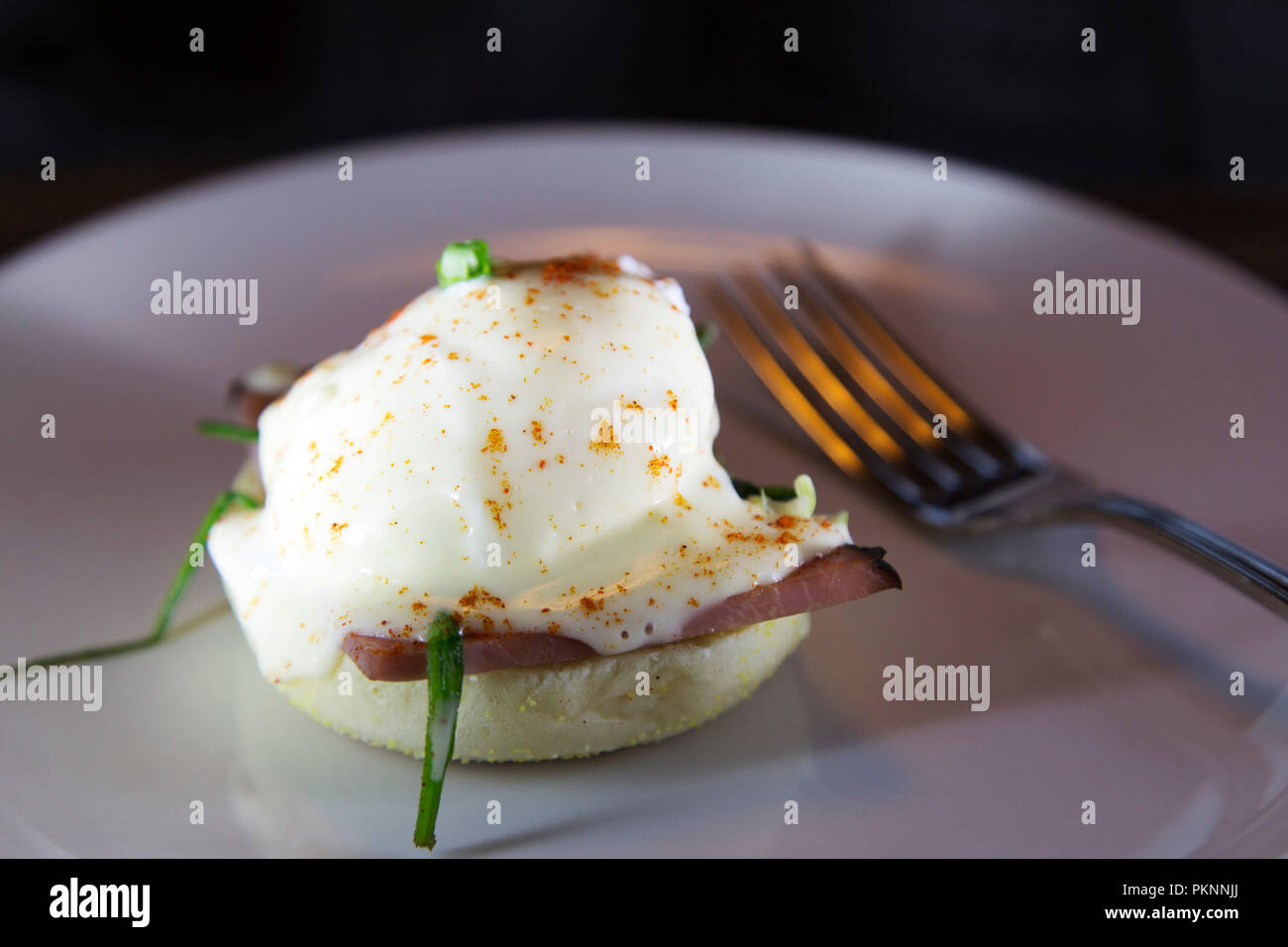 Eggs Benedict served for breakfast in Manitoba, Canada. The eggs are topped with Hollandaise sauce. Stock Photo