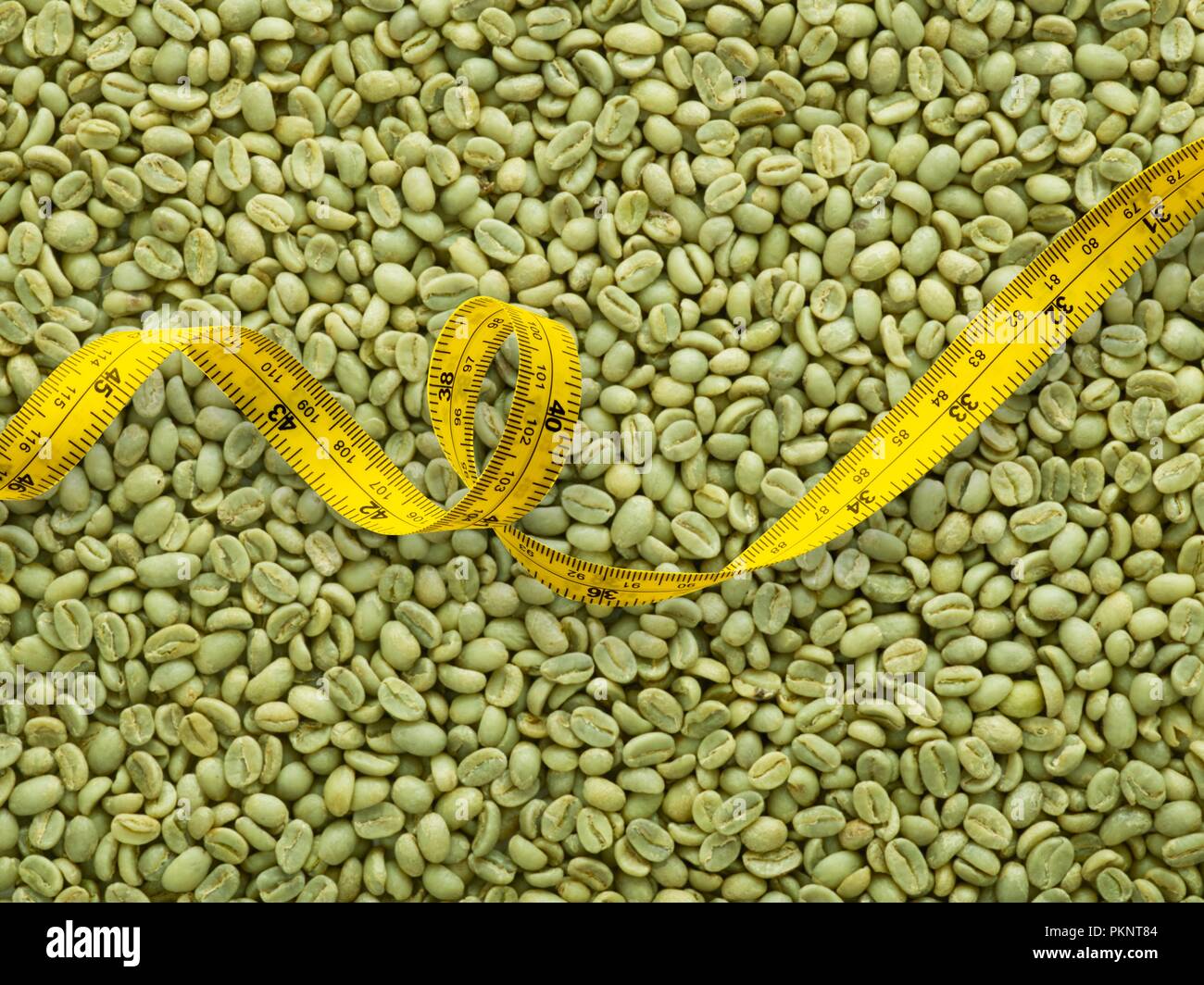 Green coffee beans and tape measure Stock Photo Alamy