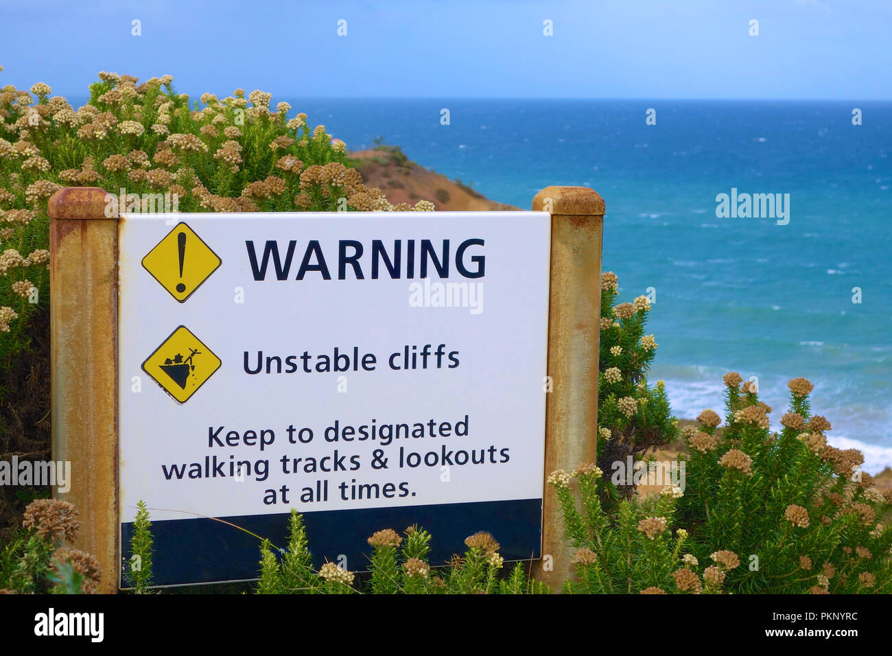 Warning sign about unstable cliffs. Stock Photo
