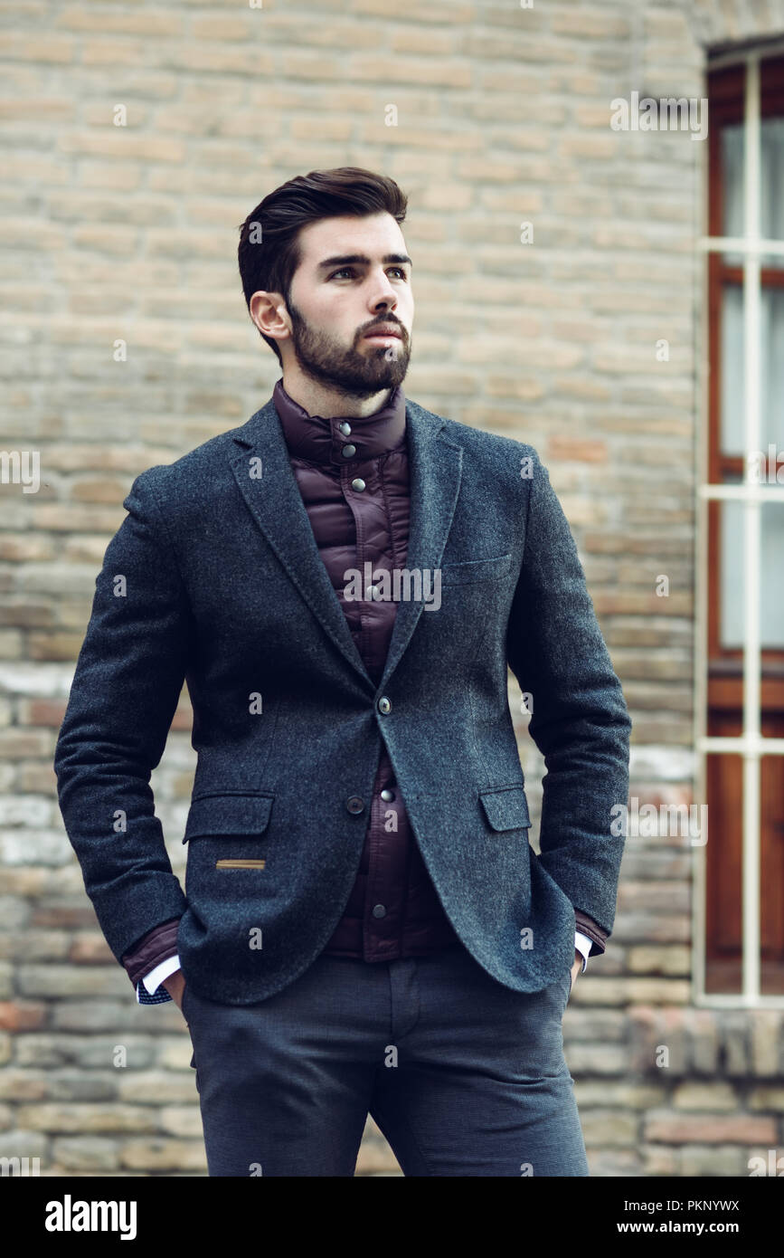 Young bearded man, model of fashion, in urban background wearing british elegant suit. Guy with beard and modern hairstyle in the street Stock Photo - Alamy Young bearded man, model of fashion, in urban background wearing british elegant suit. Guy with beard and modern hairstyle in the street Stock Photo - Alamy