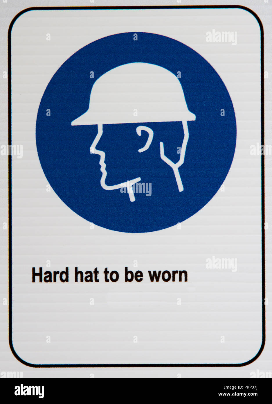 Hard hat must be worn signage at a building site. Stock Photo