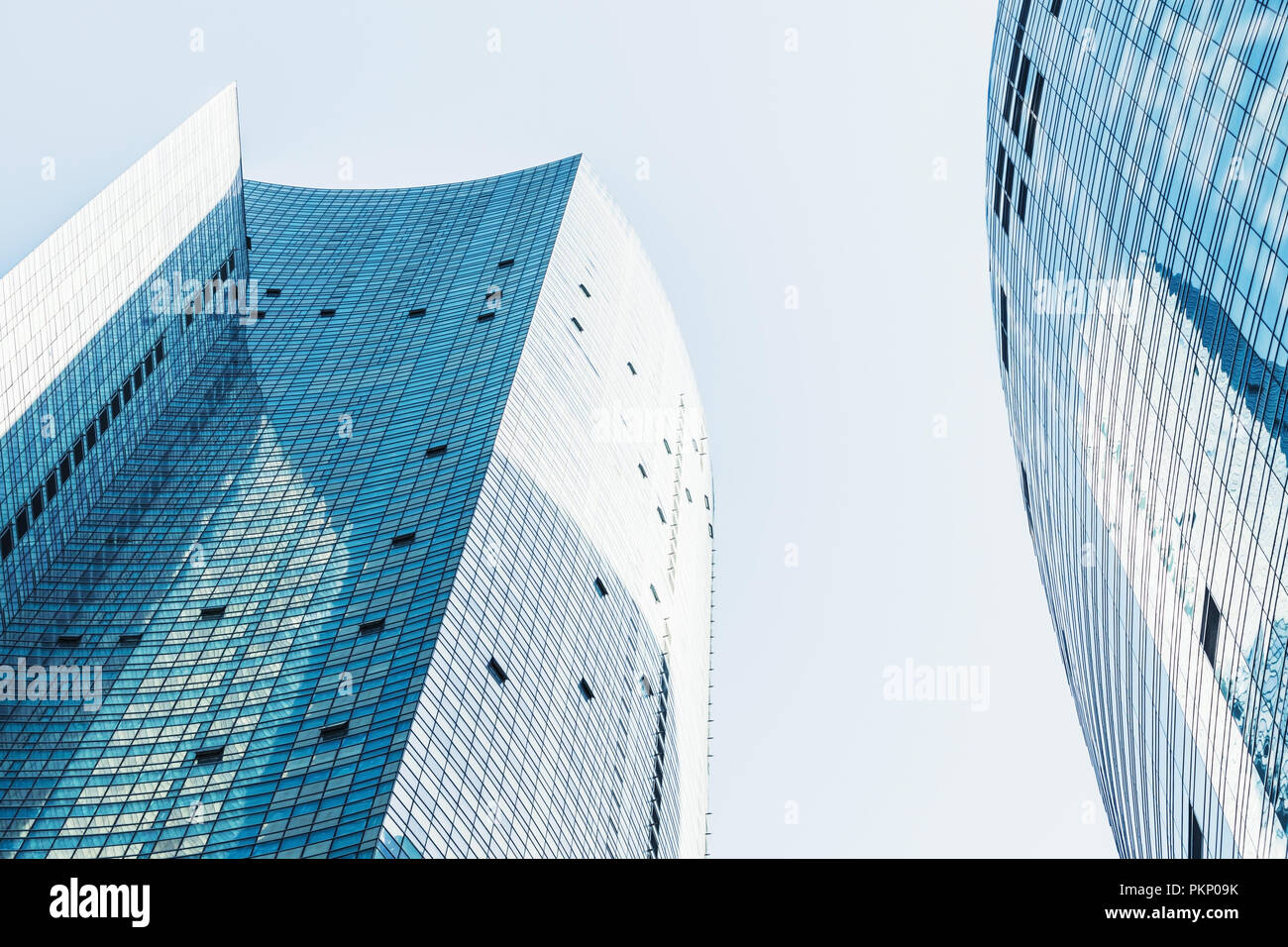 Abstract modern architecture background, cityscape with shiny office towers made of glass and steel under bright sky Stock Photo