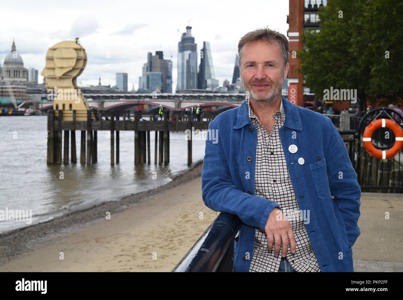 Designer Steuart Padwick with his sculpture Head Above Water, which is in support of anti-stigma mental health campaign Time to Change, at Gabriel's Pier in London. Stock Photo