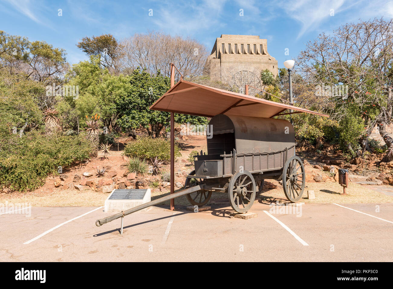 PRETORIA, SOUTH AFRICA, JULY 31, 2018: A bronze replica of a jawbone wagon with the Voortrekker Monument in Pretoria in the back Stock Photo