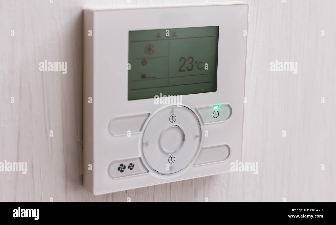 Close up of an air conditioning thermostat set to 23 degrees Stock
