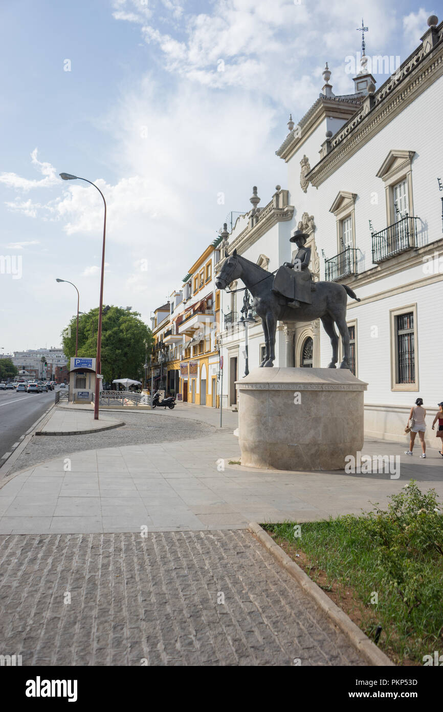 Seville, Spain - 19 June 2017: Simple statue of La Condesa de Barcelona, mother of king Juan Carlos. The Seville bullring is located behind the statue Stock Photo