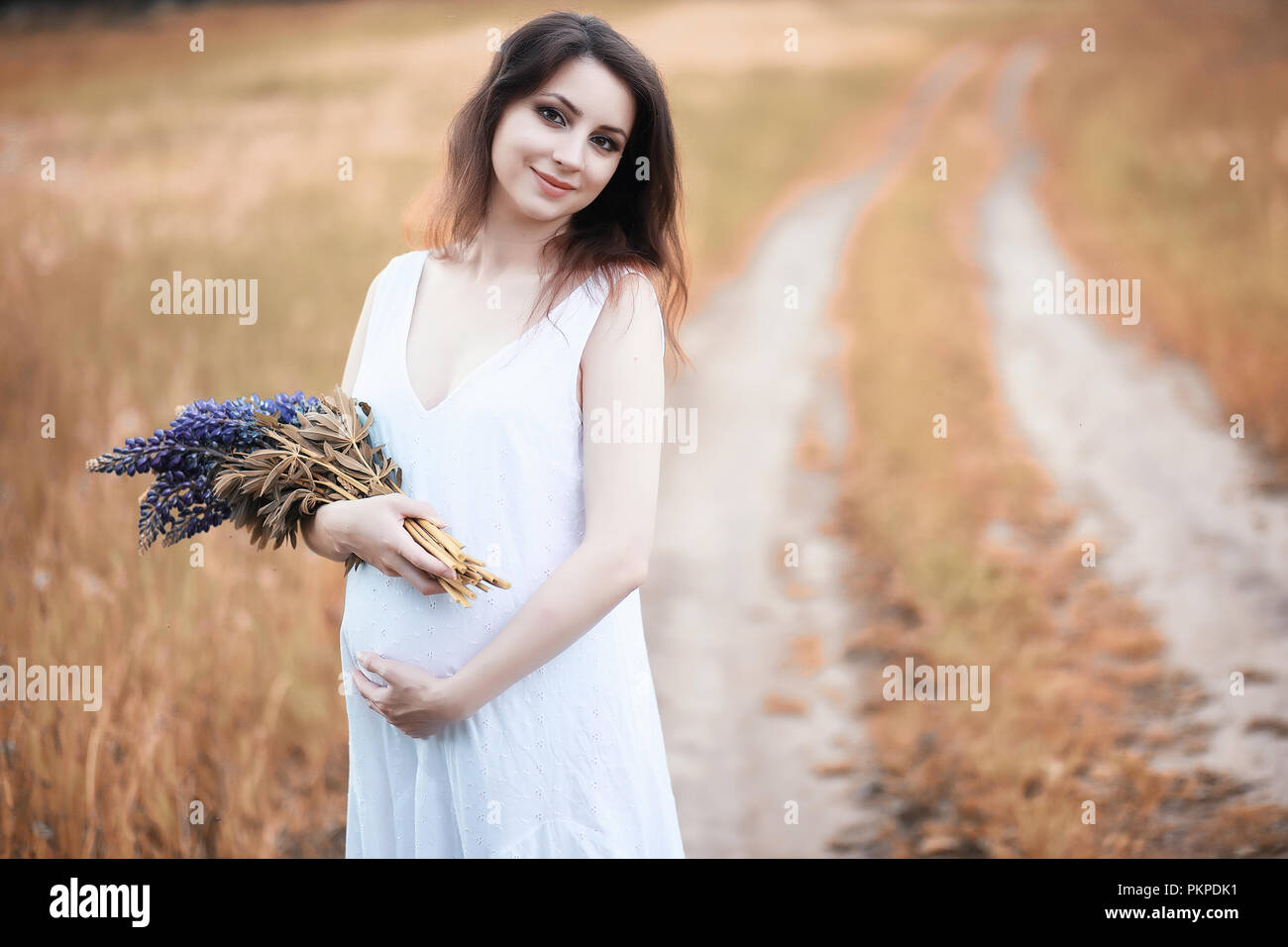 Pregnant woman in nature for a walk in the autumn Stock Photo - Alamy