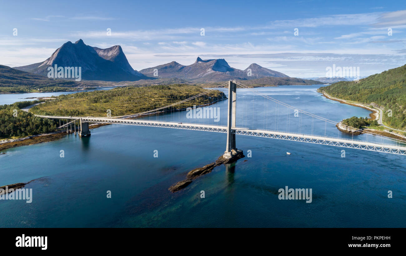 Aerial shot of a suspension bridge over Efjord with  mountain Stortinden in the background, Ballangen, Norway Stock Photo