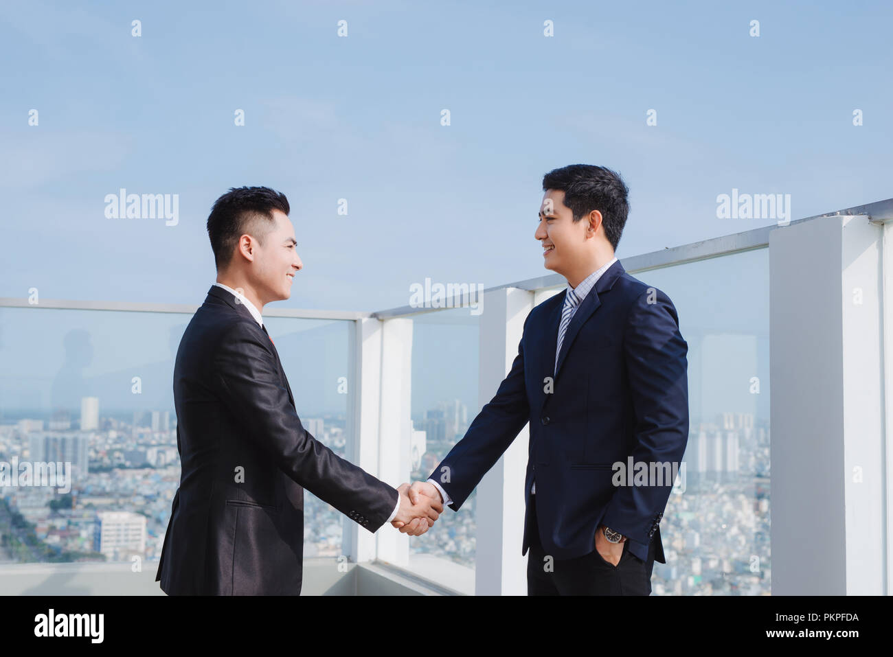 two handsome businessmen greeting each other in the street Stock Photo ...