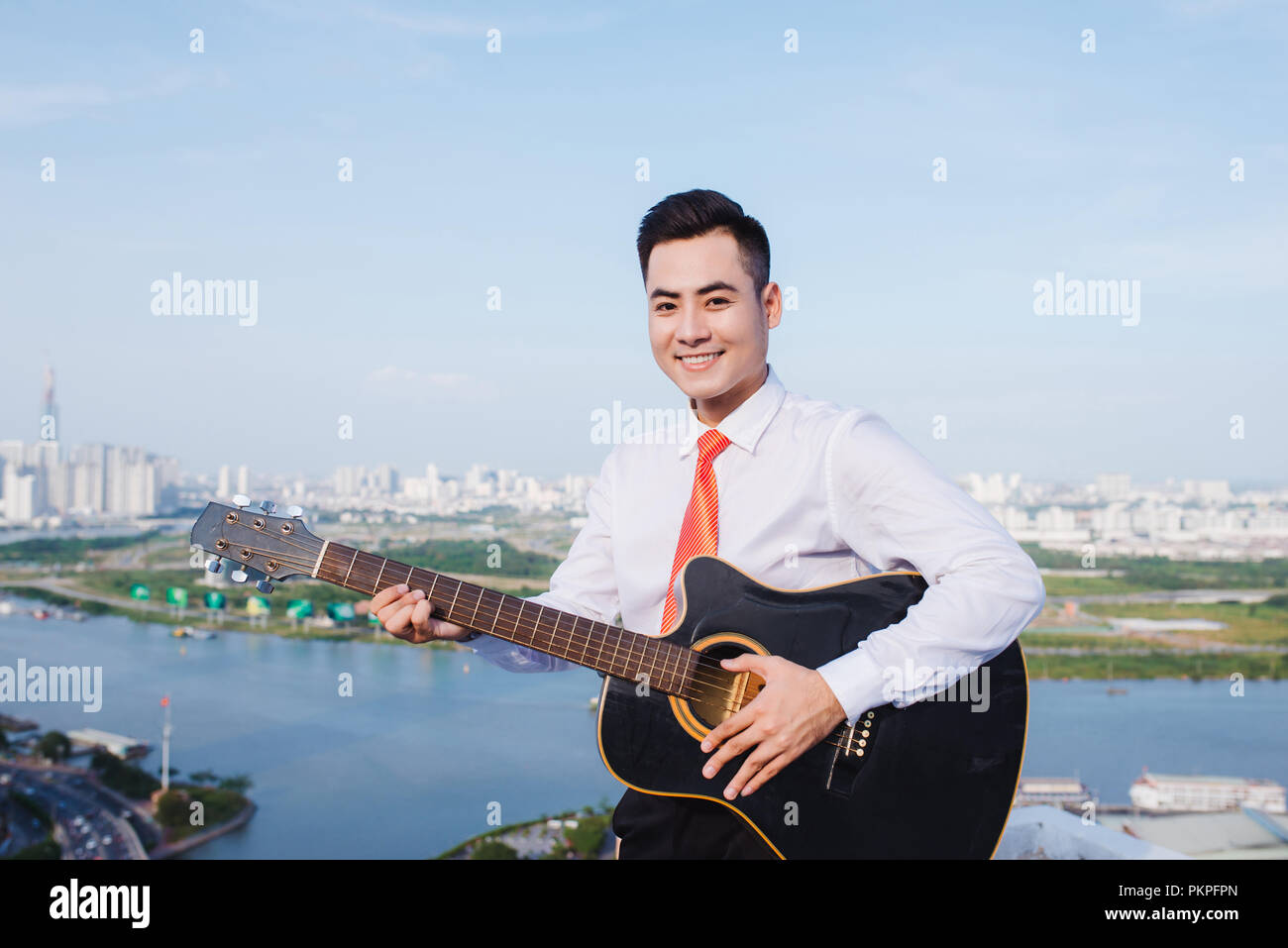 Musical Concept. Casual man playing practicing guitar. Stock Photo