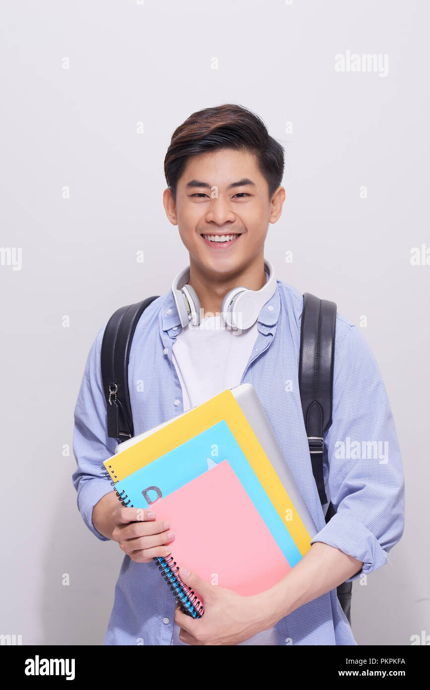 Confident asian handsome student holding books Stock Photo