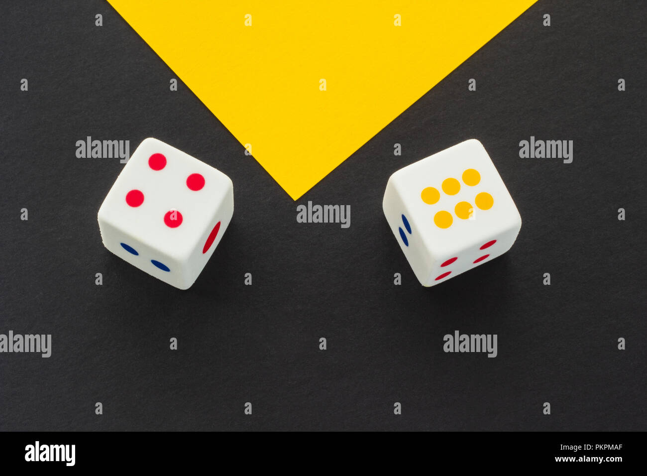 Dice on a black and yellow background Stock Photo
