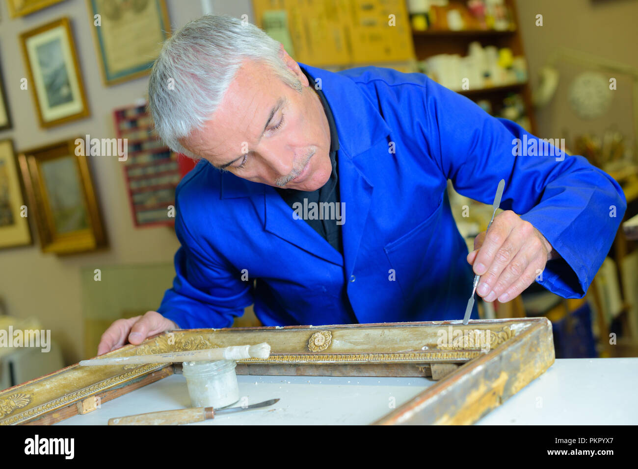 Specialist repairing picture frame Stock Photo Alamy