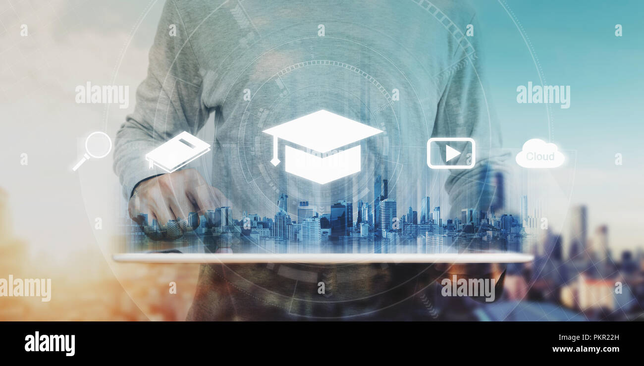 Online education, e-learning and e-book concept. a man using digital tablet for education, with education and online learning media icons Stock Photo