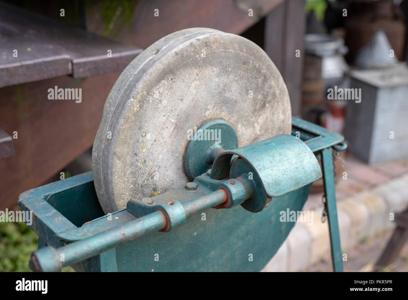 https://c8.alamy.com/comp/PKR5PR/an-old-whetstone-for-sharpening-knives-grinding-wheel-on-an-old-tripod-season-of-the-autumn-PKR5PR.jpg