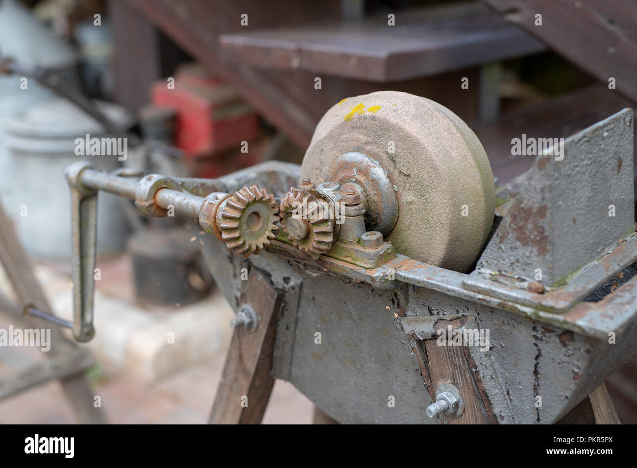 https://c8.alamy.com/comp/PKR5PX/an-old-whetstone-for-sharpening-knives-grinding-wheel-on-an-old-tripod-season-of-the-autumn-PKR5PX.jpg