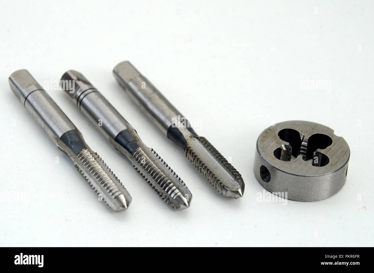 First, second, and plug tap and die for cutting of 6 mm threads. Stock Photo