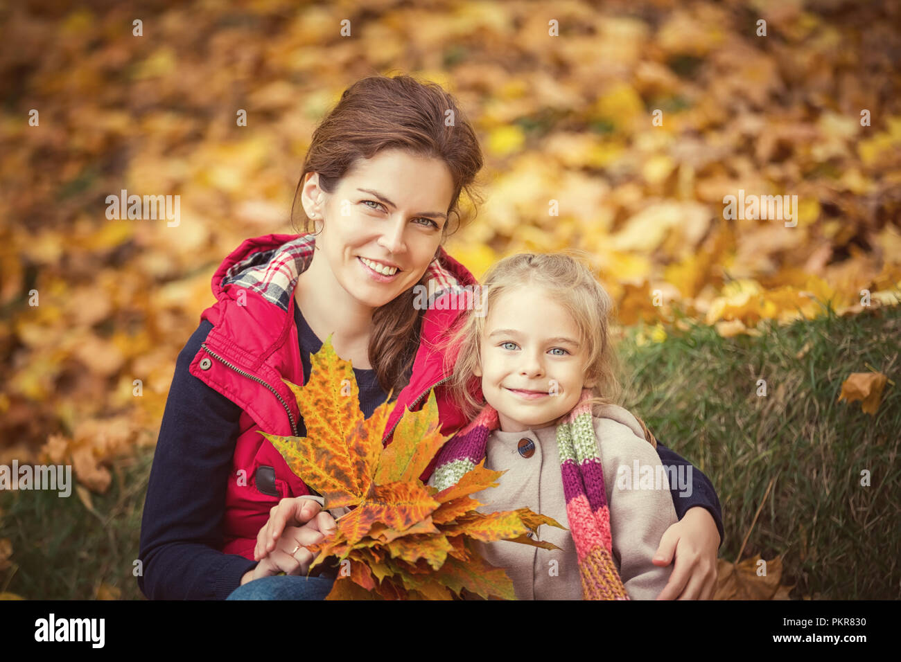 Mother and daughter in the autumn park Stock Photo - Alamy