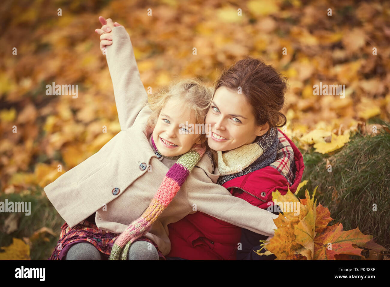 Mother and daughter in the autumn park Stock Photo - Alamy