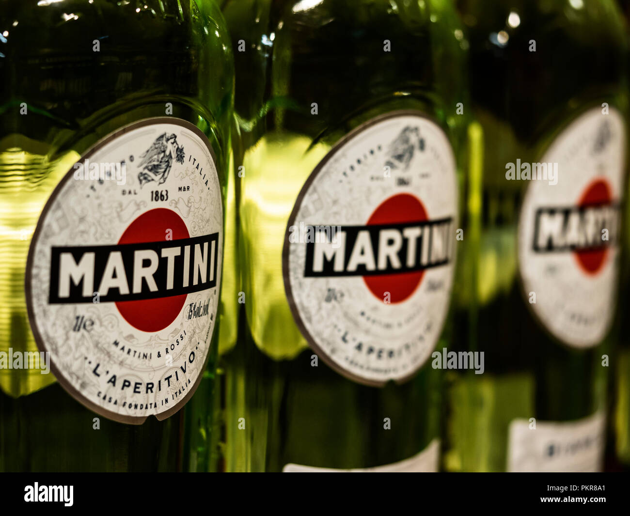 Martini bottles on store shelf. Gin is liquor which derives its
