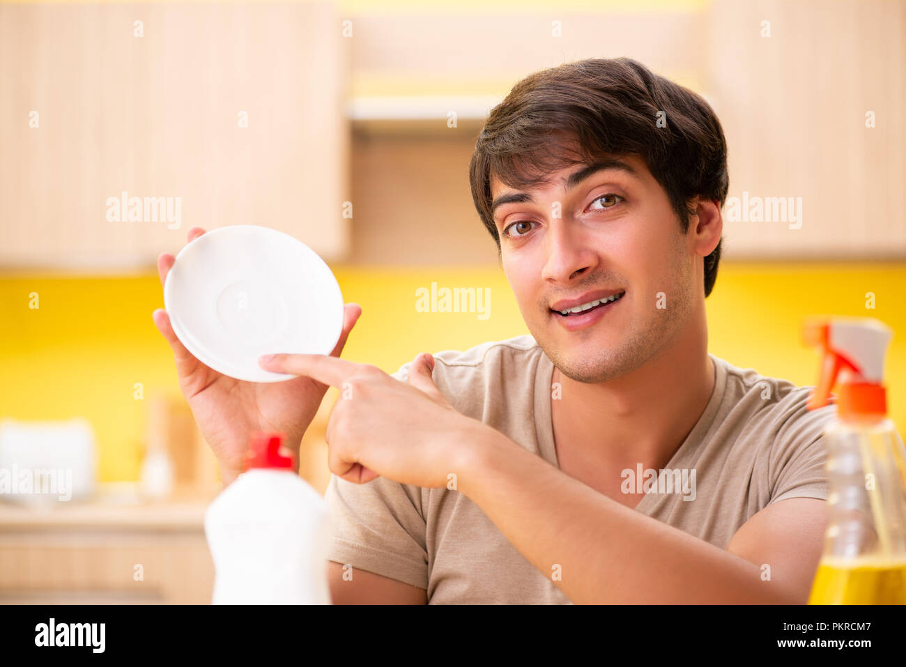 Man washing dishes at home Stock Photo