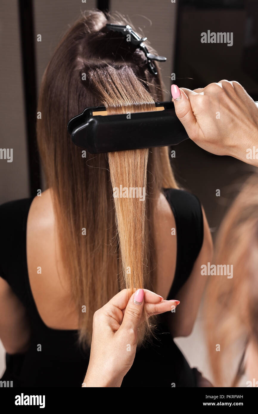 Professional Hairdresser Making A Gauffer Hairdo Of A Woman With