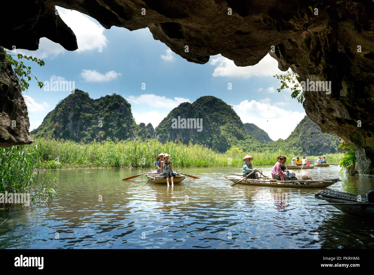 The Tourists Are Traveling By Boat Into The Cave In Ninh Binh Province Landscape In Van Long Wetland Nature Reserve In N Stock Photo Alamy