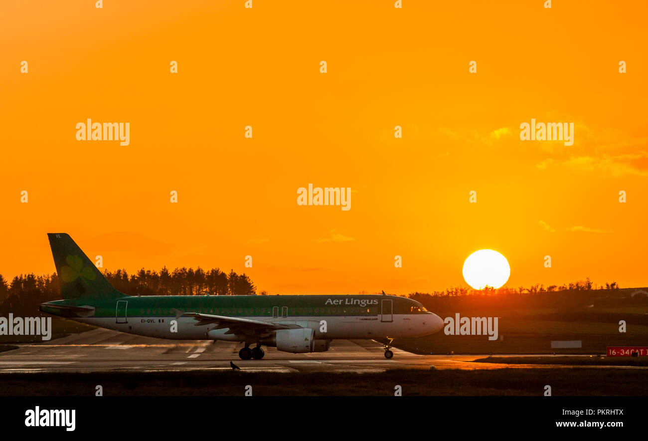 Cork, Ireland. 02nd May 2018. Aer Lingus flight EI866 to Barcelona just about to take off from runway 16/34  just as the sunrises at Cork Airport, Co. Stock Photo
