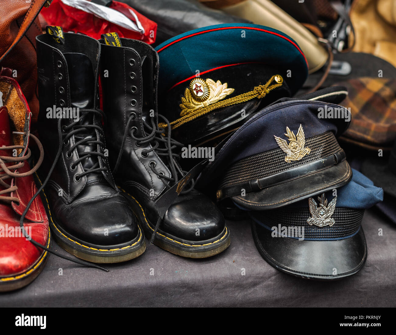 Vintage military caps and boots on flea market in Tel Aviv, Israel Stock Photo