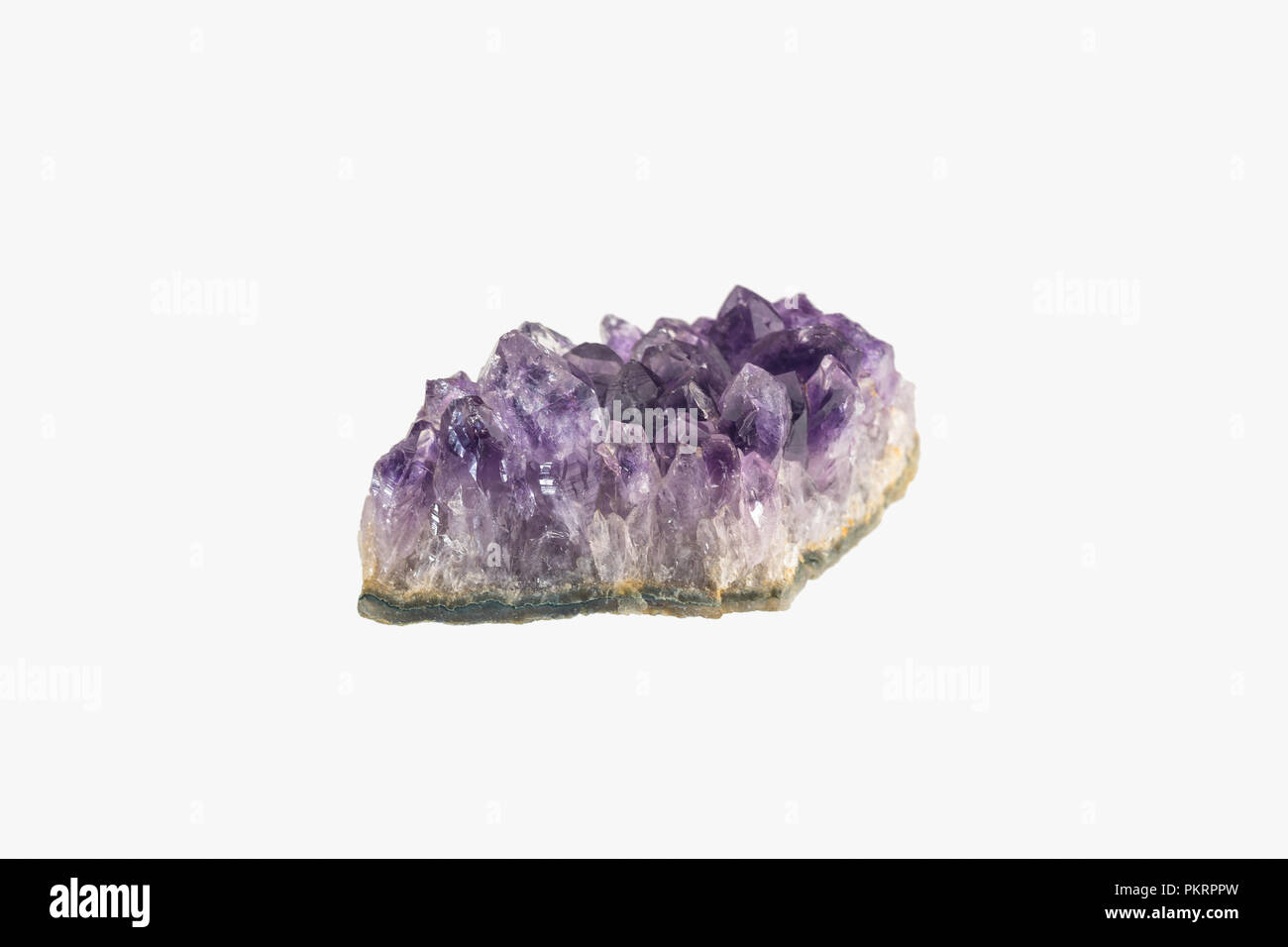 Amethyst druse isolated. Purple rough amethyst crystals. Stock Photo