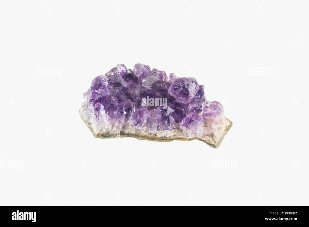 Amethyst druse isolated. Purple rough amethyst crystals. Stock Photo