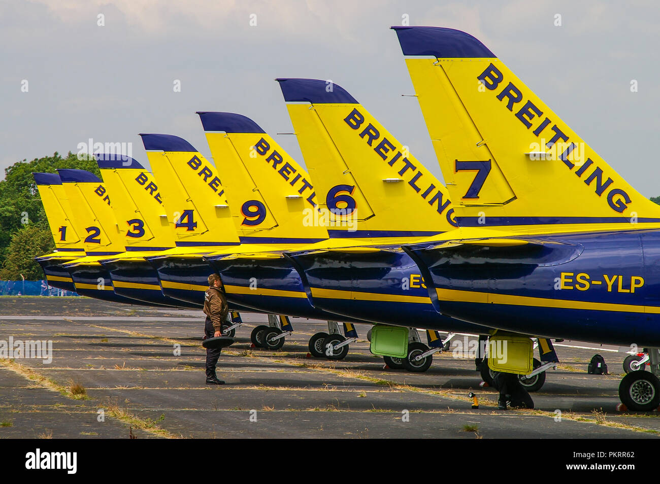 Breitling Jet Team line up of L-39 jet planes with engineer peering into jet pipe. Aerovodochody Aero L-39 Albatros jets. Inspection. Exhaust Stock Photo